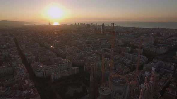 Flying over Barcelona and Sagrada Familia at sunset