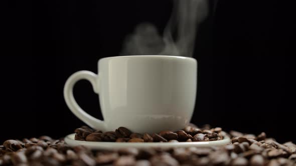 Hot coffee. Coffee cup and coffee beans. Hot ceramic coffee cup with smoke