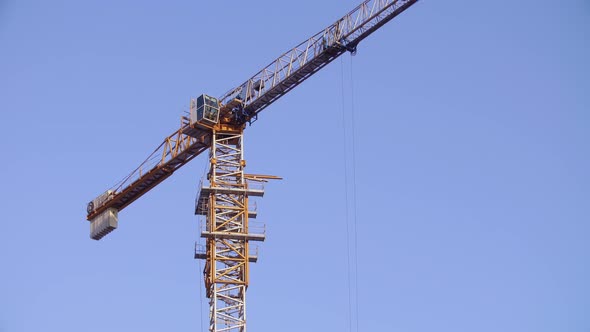 Tower Crane Working on Construction Site Sunny Day Clear Blue Sky