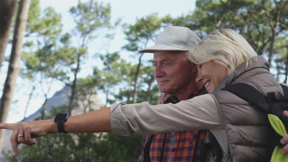 Side view of active senior couple in forest