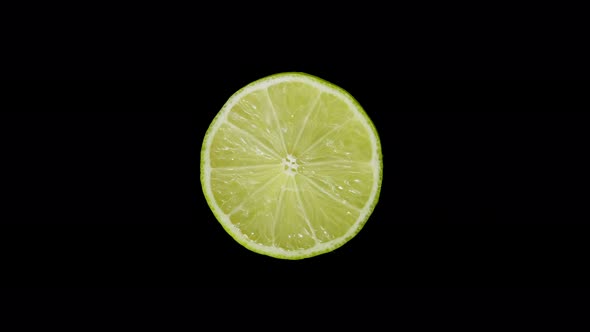 Iolated Lime Cut with a Knife in the Studio on a Black Background