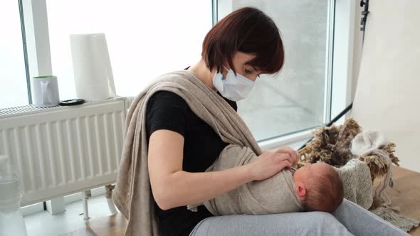 Woman Swaddles Newborn Baby