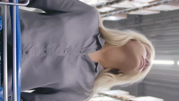 Vertical View of Young Blonde Girl with Shopping Cart at Mall