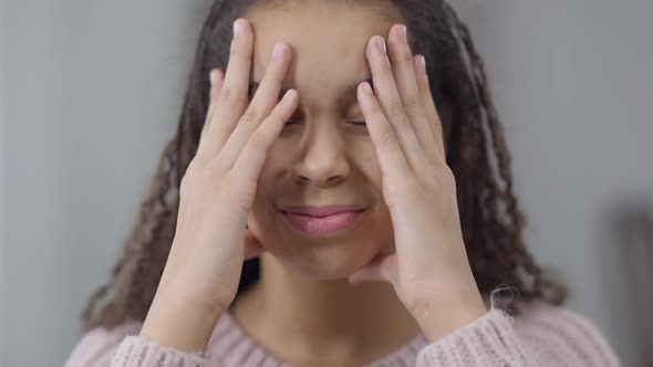 Headshot of Burnt Out Fatigued African American Teen Girl Rubbing Temples Having Headache Migraine