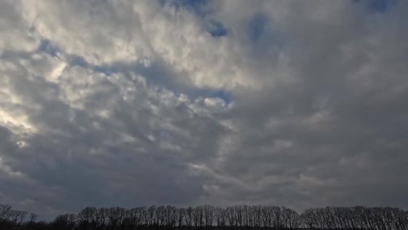 beautiful time lapse of clouds and sun floating fast across the sky