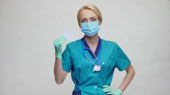 Medical Doctor Nurse Woman Wearing Protective Mask and Gloves - Showing Blank Business Card