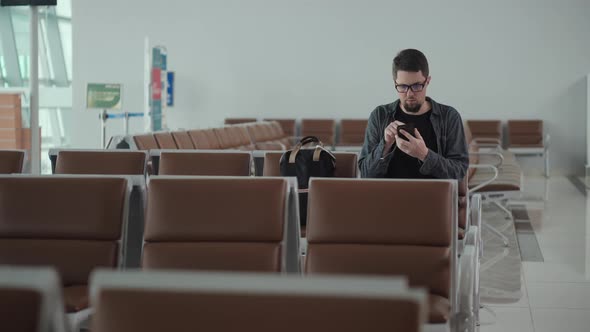Traveler in Terminal of Airport Waiting Connecting Wifi