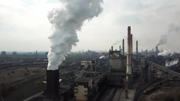 Smoke and soot from a steel mill. Aerial view at dawn. Harmful production and air pollution