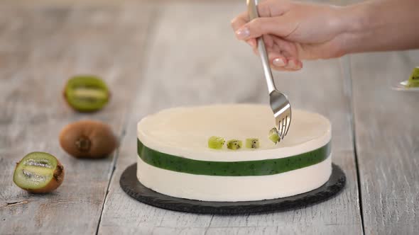 Chef Decorate The Cake With Fresh Kiwi. Homemade Mousse Cake With Kiwi