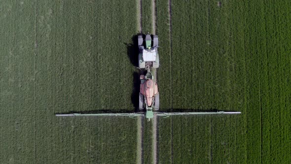 Tractor Spraying a Controversial Glyphosate Herbicide on Agricultural Land