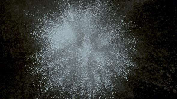 White powder exploding on black background in super slow motion, shot with Phantom Flex 4K alt