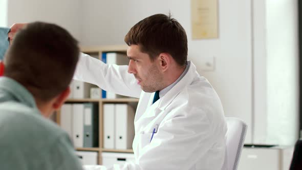 Doctor with X-ray and Male Patient at Hospital 31