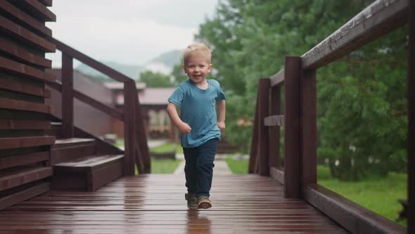 Little Boy Runs to Hug Loving Parent Along Veranda Deck