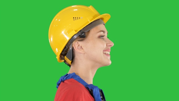 The young woman engineer with yellow safety helmet walking