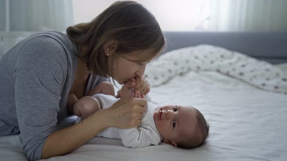 Beautiful Young Mother with a Baby Girl at Home