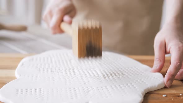 Handcraft Woman Master Modeling Cold Porcelain Hands Makes Pattern and Texture on the Dough Beats It