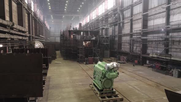 Green Main Engine on Pallets Near Fishing Vessel in Dry Dock