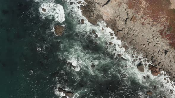 Drone looking down on waves wash up on shore  Beach Bodega Bay Highway 1 in Northern California