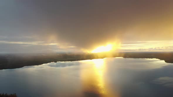 Aerial view sunset over the forest and lake. 