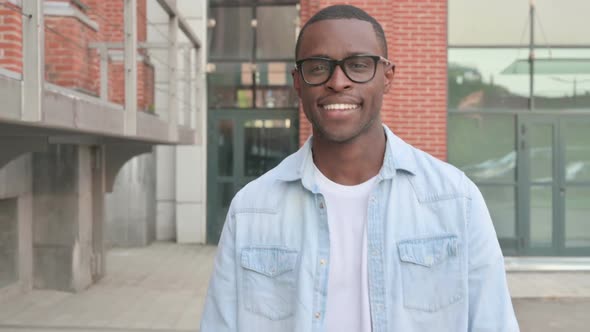 Close Up of Smiling African Man Walking in Street Front Pose