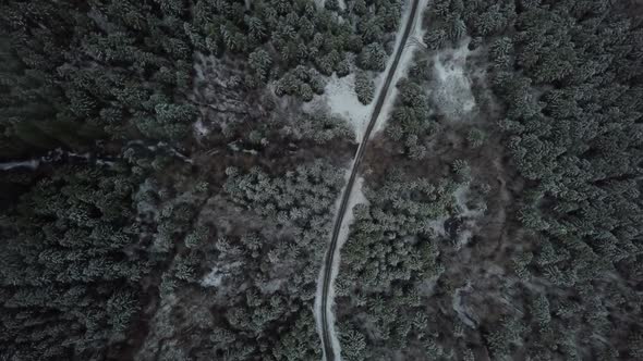 High angle aerial shot of road in a frozen forest, Vancouver Island, Canada