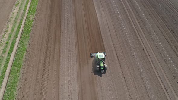 Tractor with Harrows on the Farmland