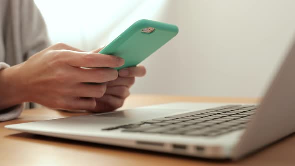 Woman Using Cellphone and Laptop Computer