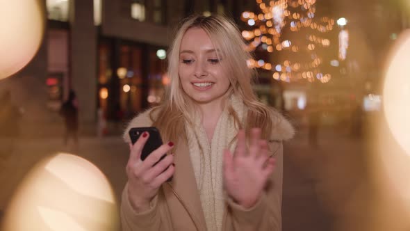 attractive lady shops online with her phone to find the perfect gift