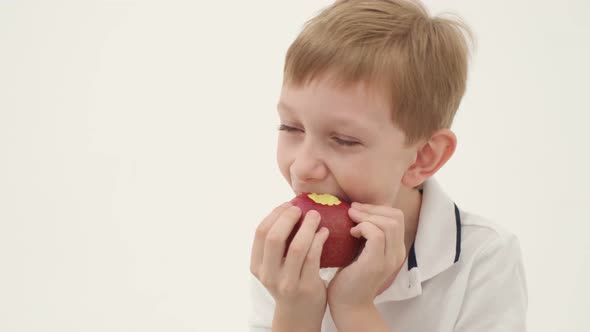 Little Boy Missing Some Teeth Eats Red Apple