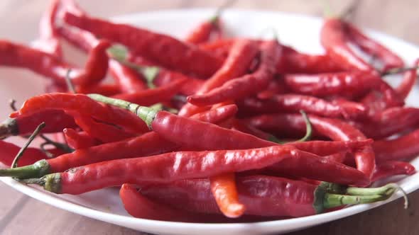 Slow Motion of Red Chili Pepper Dropping on a Plate