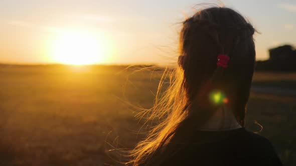 Close Back View Young Free Girl Looking Enjoying Landscape Sunset Wind in Her Hair