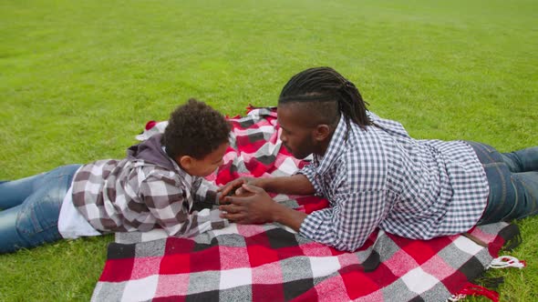 Caring African Dad Comforting Sad Little Son Outdoors