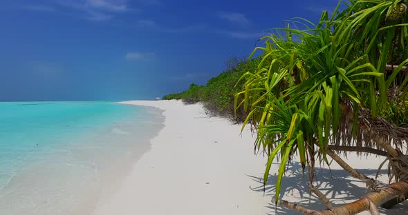 Wide angle aerial island view of a sandy white paradise beach and turquoise sea background in colour