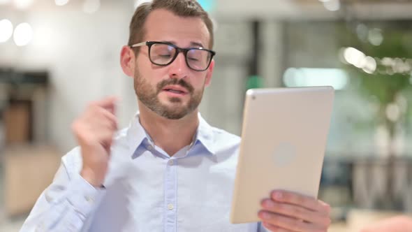 Portrait of Businessman Doing Video Call on Digital Tablet