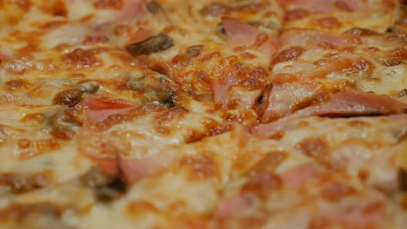 Slow pan over tasty baked pizza surface close-up 4K 2160p 30fps UltraHD footage - World famous Itali
