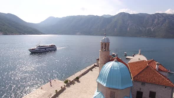 Tourist Ship Sails Past the Island with the Church of Our Lady of the Rocks