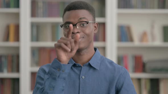 Young African Man Pointing at the Camera