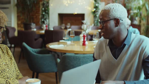 African American Colleagues Talking over Coffee in Cafe