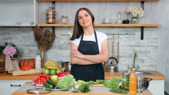 Attractive Smiling Young Housewife Posing at Cozy Kitchen During Cooking Fresh Appetizing Food