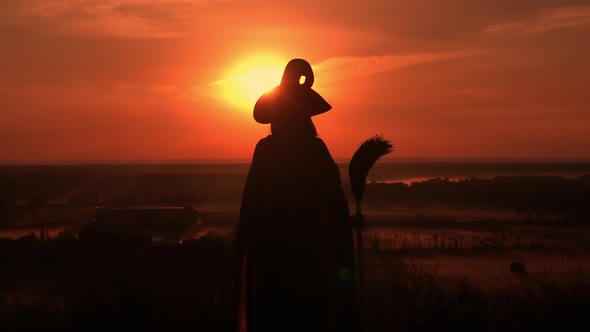 Witch Standing on the Mountain Landscape at Sunrise