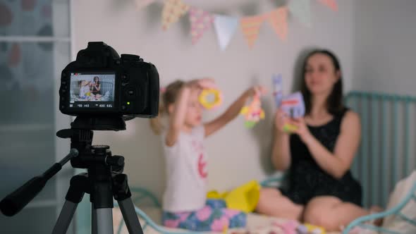 Woman with Daughter Filming Content for Vlog