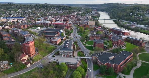 Downtown Morgantown West Virginia. WVU buildings and Monongahela River. Aerial truck shot at golden