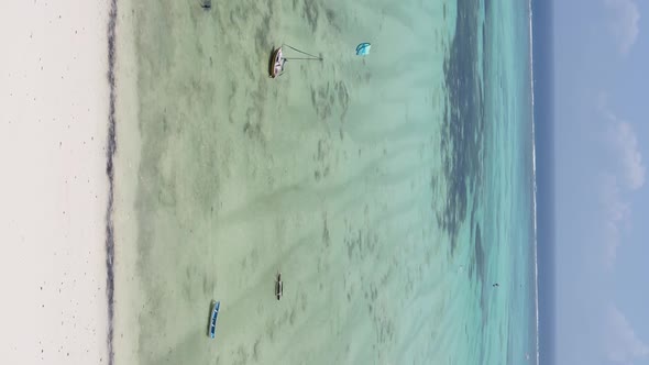 Zanzibar Tanzania  Vertical Video Kitesurfing Near the Shore of Ocean Slow Motion