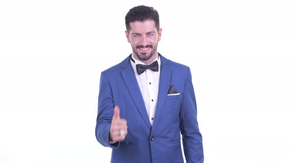 Happy Young Handsome Bearded Businessman Giving Thumbs Up