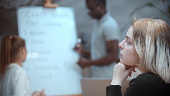 English Lesson in the Class with a Black Teacher - Two Women Sitting By the Table