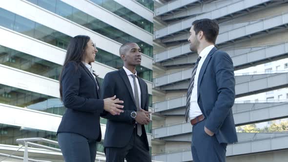 Cheerful Business People Talking on Street