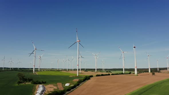 A Drone Shot of a Massive Wind Farm in Agricultural Land