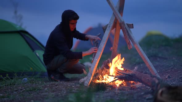 Camping Tent and Campfire at Night in Mountains