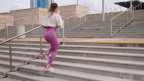 Outdoors Training in City Woman is Running Over Stairs Tensing Legs Muscles