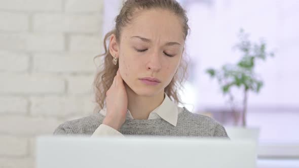 Young Latin Woman Having Neck Pain in Office